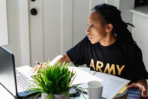 Photo of an Army Veteran Using a laptop to do school work at home